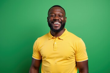 Fototapeta premium Happy African American Man in Yellow Polo Shirt Smiling Confidently Perfect for Diversity and Inclusion Campaigns