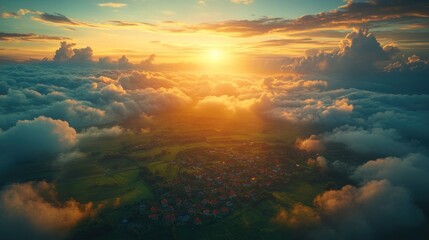 Fototapeta premium Aerial view of village at sunset above clouds.