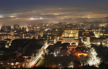 Fog on Bergamo in the night, Lombardy, Italy
