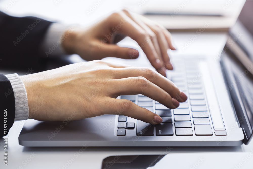 Poster with a blurred office environment in the backdrop, the image focuses on a woman's hands typing on a 
