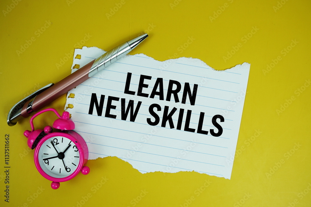 Aufkleber Learn New Skills text on paper torn with alarm clock top view on yellow background