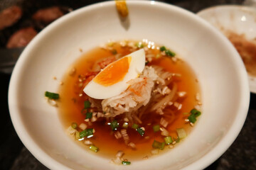close up of cold Japanese water noodles with vinegar and boiled egg slice, spring onion and sesame