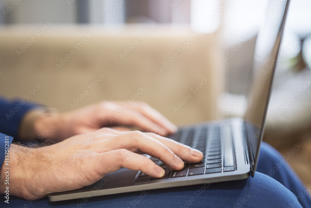 Aufkleber in a close-up, a man's hands can be seen typing on a modern laptop keyboard, with the office setting
