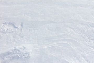 A white snow covered ground with a few footprints