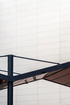 An image depicting a minimalist architectural structure with a plain wall background, emphasizing simplicity and contemporary design, inviting viewers to reflect on space and form.