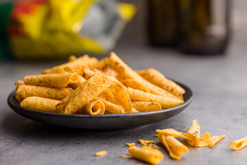 Rolled nachos tortilla chips on plate on kitchen table.