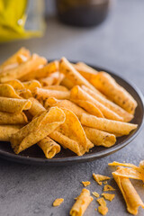 Rolled nachos tortilla chips on plate on kitchen table.