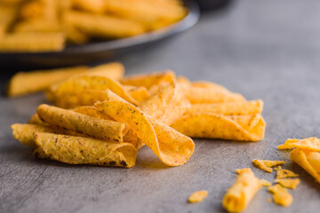 Rolled nachos tortilla chips on kitchen table.