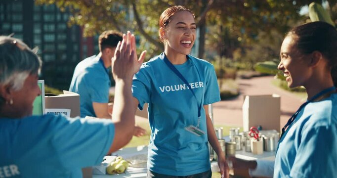 Charity, high five and volunteer group of people outdoor in community for activism or welfare. Boxes, success and support with friends in park together for NGO altruism, partnership or teamwork