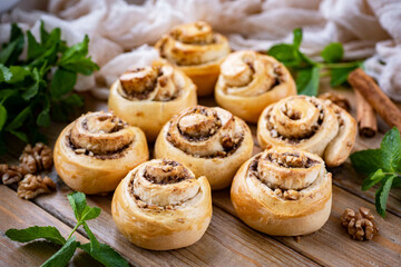 The buns are sweet. Homemade sweet rolls with nuts for breakfast. Sweet pastries for dessert. Close-up