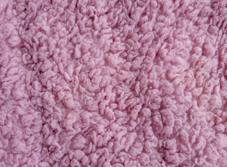 pink knitted fabric Wool surface blanket carpet photographed in close-up in pink color feel the material texture
