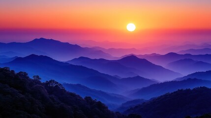 Vibrant sunset over a mountain range with mist.