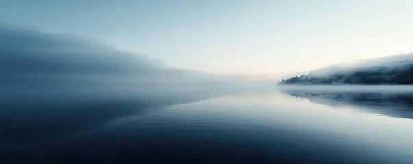 Fototapeta premium Mysterious fog concept. A tranquil lake during foggy morning, reflecting the calm blue sky and serene atmosphere.