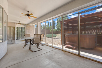 Enclosed patio with modern seating and open view.