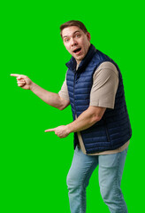 Man in a navy vest gestures enthusiastically toward a green screen