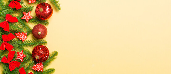 Set of festive balls, fir tree and Christmas decorations on colorful background. Top view of New Year ornament concept with copy space