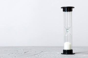 hourglass on the table, sand clock as time passing concept for business deadline, copy space