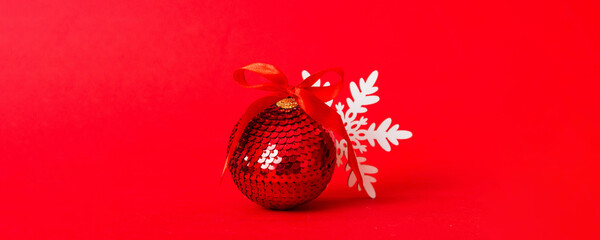 Christmas ball on colored background. decoration bauble with ribbon bow with copy space