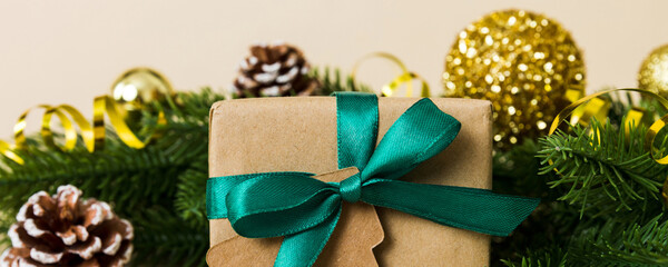 New Year Christmas mood, gift box, branches of a christmas tree, New Year decorations on a colored background