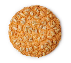 Oatmeal cookie with sunflower seeds on a white background highlighting its texture and color