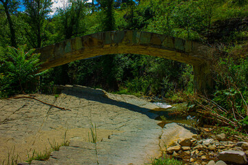 Stone old bridge over the river in city Tbilisi, Georgia