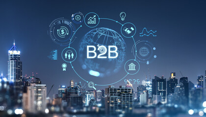 Business-to-business concept with glowing icons over a cityscape at night.