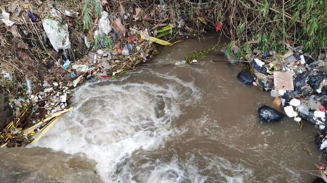 The river flow is dirty and full of rubbish