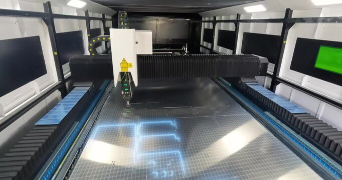CNC laser cutting machine at work. metal laser cutting machine. CNC laser machine at the factory. Cutting metal with a laser CNC machine.
