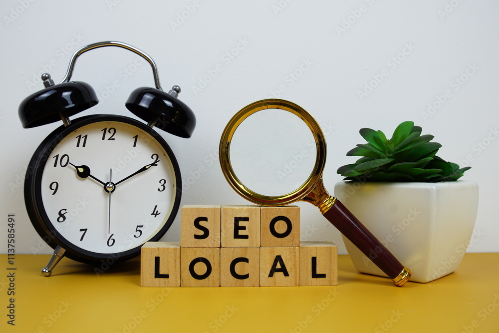 Poster magnifying glass and alarm clock with wooden blocks alphabet letters seo local text message on yello