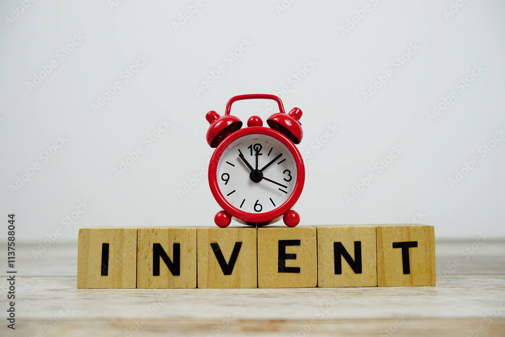 Aufkleber time to invent with wooden blocks alphabet letters and alarm clock on wooden background