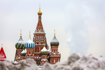 View to St Basil's Cathedral through snow drifts on Red square in Moscow, russian winter