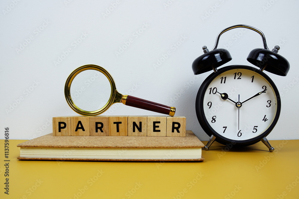 Poster magnifying glass and alarm clock with wooden blocks alphabet letters partner text message on yellow 