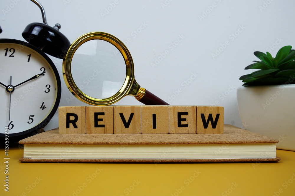 Poster magnifying glass and alarm clock with wooden blocks alphabet letters review text message on yellow b