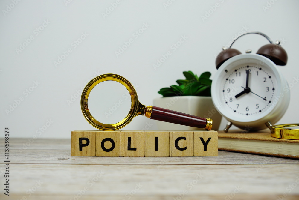 Poster magnifying glass and alarm clock with wooden blocks alphabet letters policy text message on wooden b