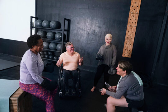 Friends talking in gym