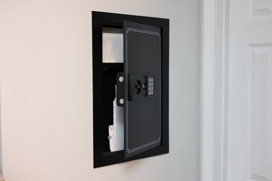 A close-up of a hidden in-wall safe discreetly installed within a wall. The sleek design emphasizes security and practicality for safeguarding valuables.