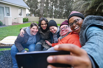 Friends by fire pit in garden