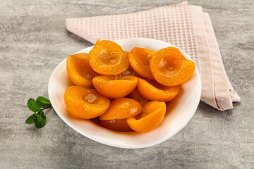 Sweet canned apricots with syrope