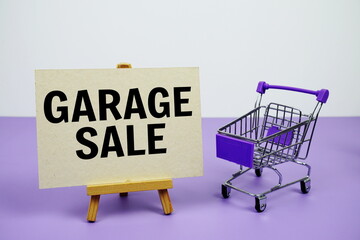 Garage Sale text message and trolley shopping cart on purple background