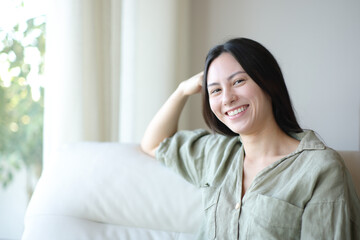 Asian woman posing looking at camera at home