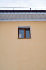 A window on a building with a brown frame