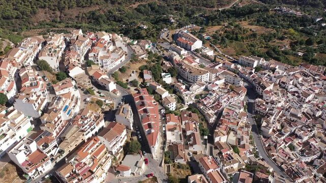 Drone view of the small town with white houses and surrounding countryside, Ojen, Spain in the summer