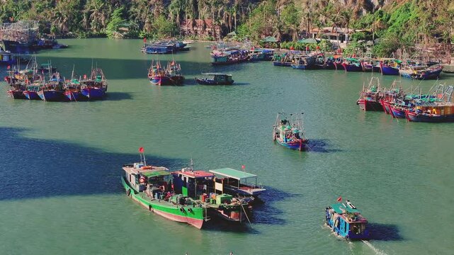 Fly over typical colourful fishing boats, in the morning, in Ha Long Bay, North Vietnam. Perfect for travel themes or exploring foreign cultures.