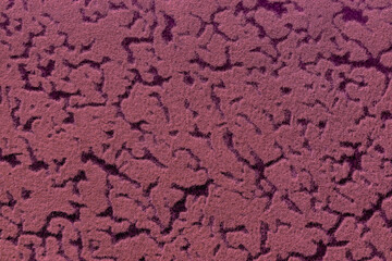 Purple and black background from soft upholstery textile with abstract pattern, macro. Texture wine felt fabric.