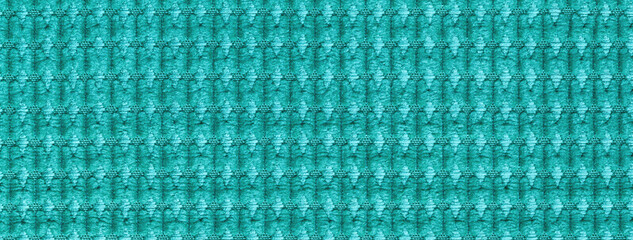 Texture turquoise and cyan fluffy fabric background with pattern, macro. Abstract backdrop from cerulean textile