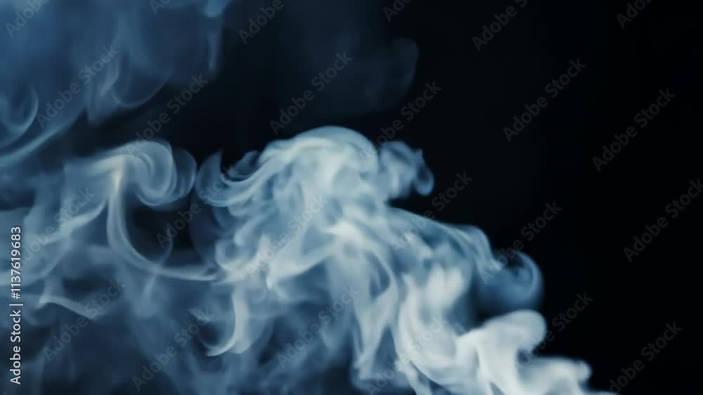 Poster wisps of smoke drift gracefully against a dark background creating a mesmerizing visual display