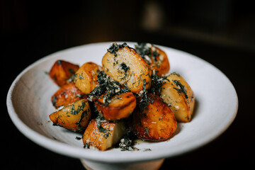 Fried Potatoes Garnished With Fresh Herbs Served on a White Plate Highlighting a Delicious Side Dish Perfect for Any Meal
