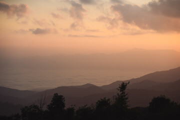 landscape and travel concept with sunrise and layer of mountain and mist with forest on morning