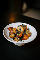 Delicious Fried Potatoes Garnished With Fresh Herbs Served on a White Plate, Perfect for a Delightful Meal