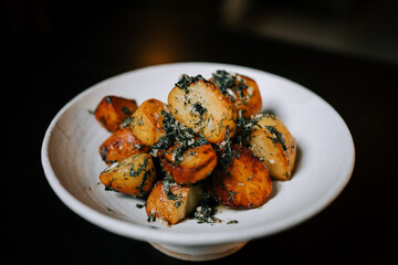 Fried Potatoes Garnished With Fresh Herbs Served on a White Plate, Perfect for Any Meal at Any Time of Day